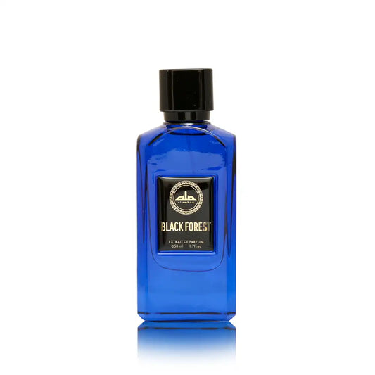 A rectangular cobalt blue glass perfume bottle by Al Ambra Perfumes, featuring a thick black cap. The central black label, framed in gold, reads "AL AMBRA PERFUMES" logo at the top and "BLACK FOREST" in large gold text, with "Extrait de Parfum 50 ml / 1.7Fl.oz." below. The product stands on a reflective white surface.
